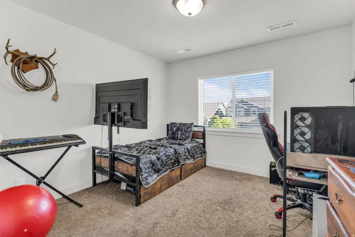 Bright room featuring neutral carpet flooring and white walls