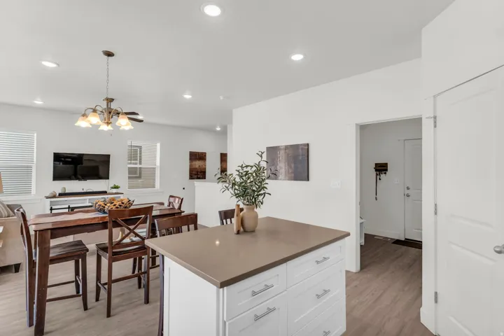 Kitchen island with a solid surface countertop and white cabinetry