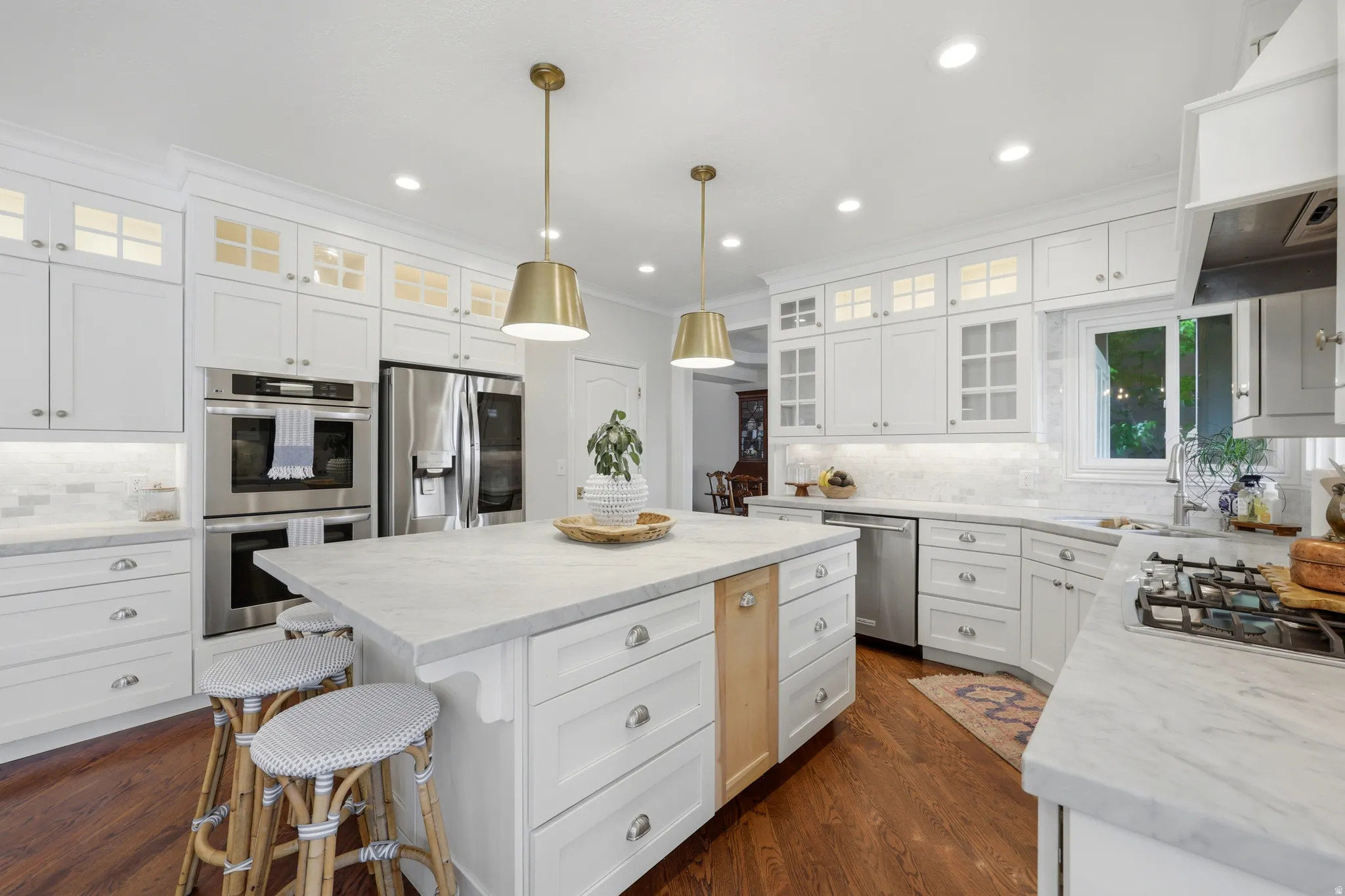 Spacious kitchen with white cabinetry and light-toned countertops