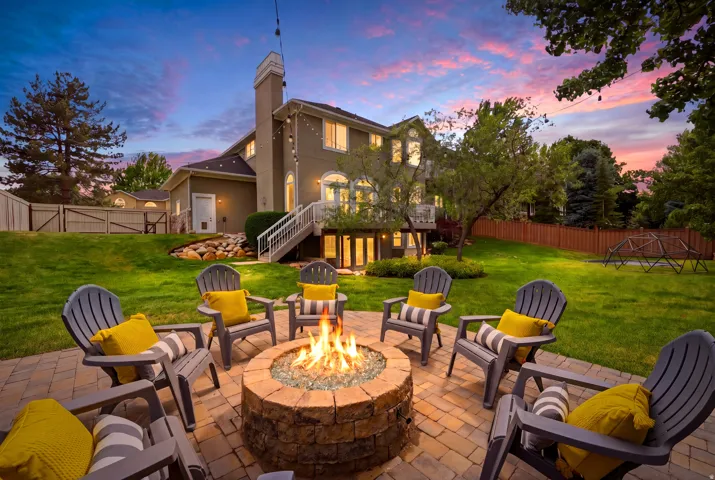 Expansive paver patio featuring a stone fire pit