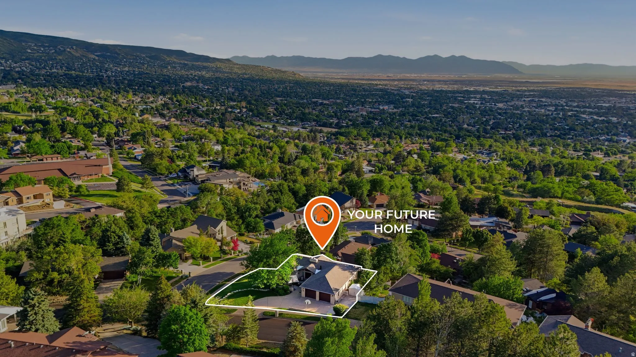 Aerial perspective showcasing a residential property with a multi-car driveway and an attached garage