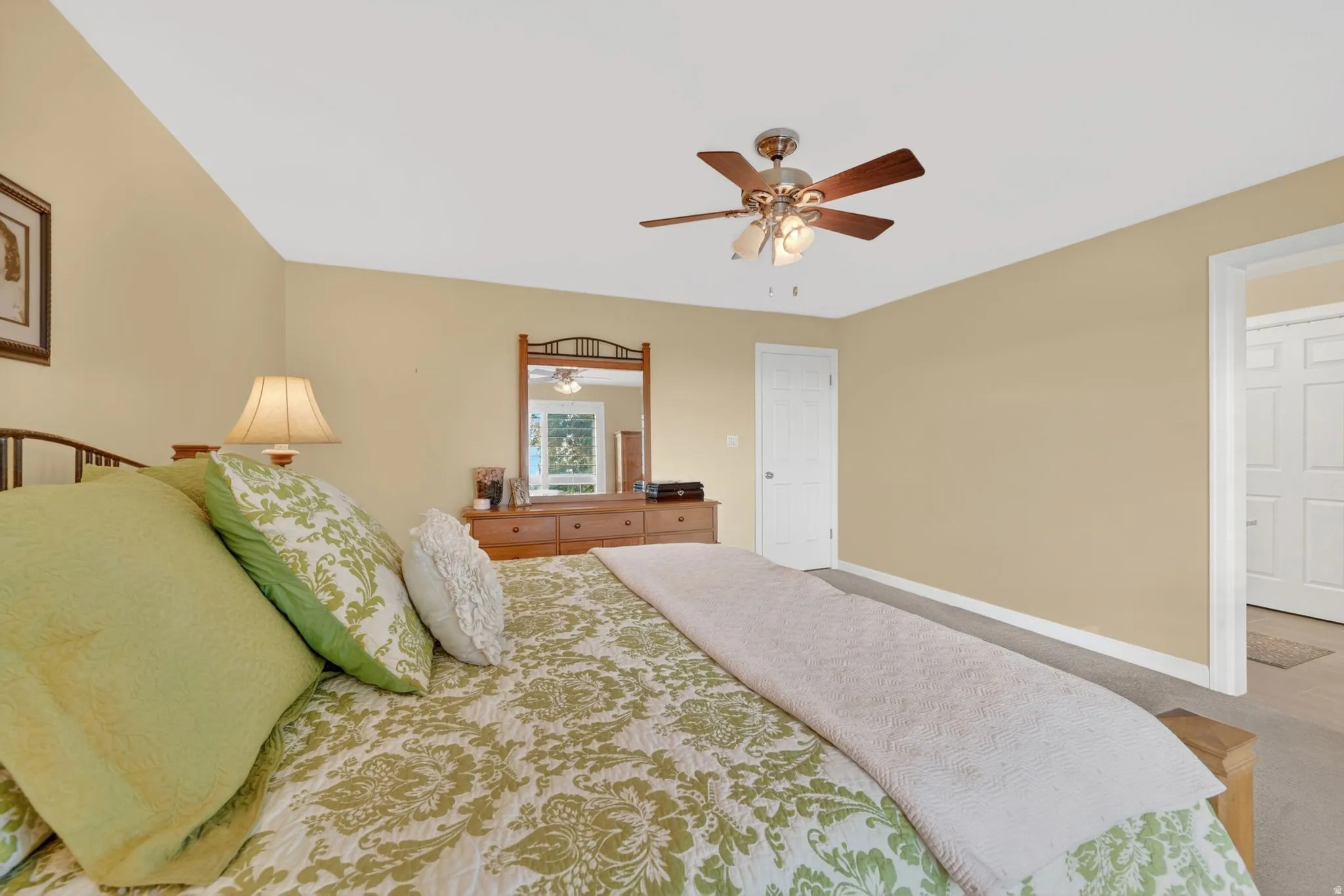 Spacious room featuring neutral wall tones, a ceiling fan with integrated lighting, and white baseboards
