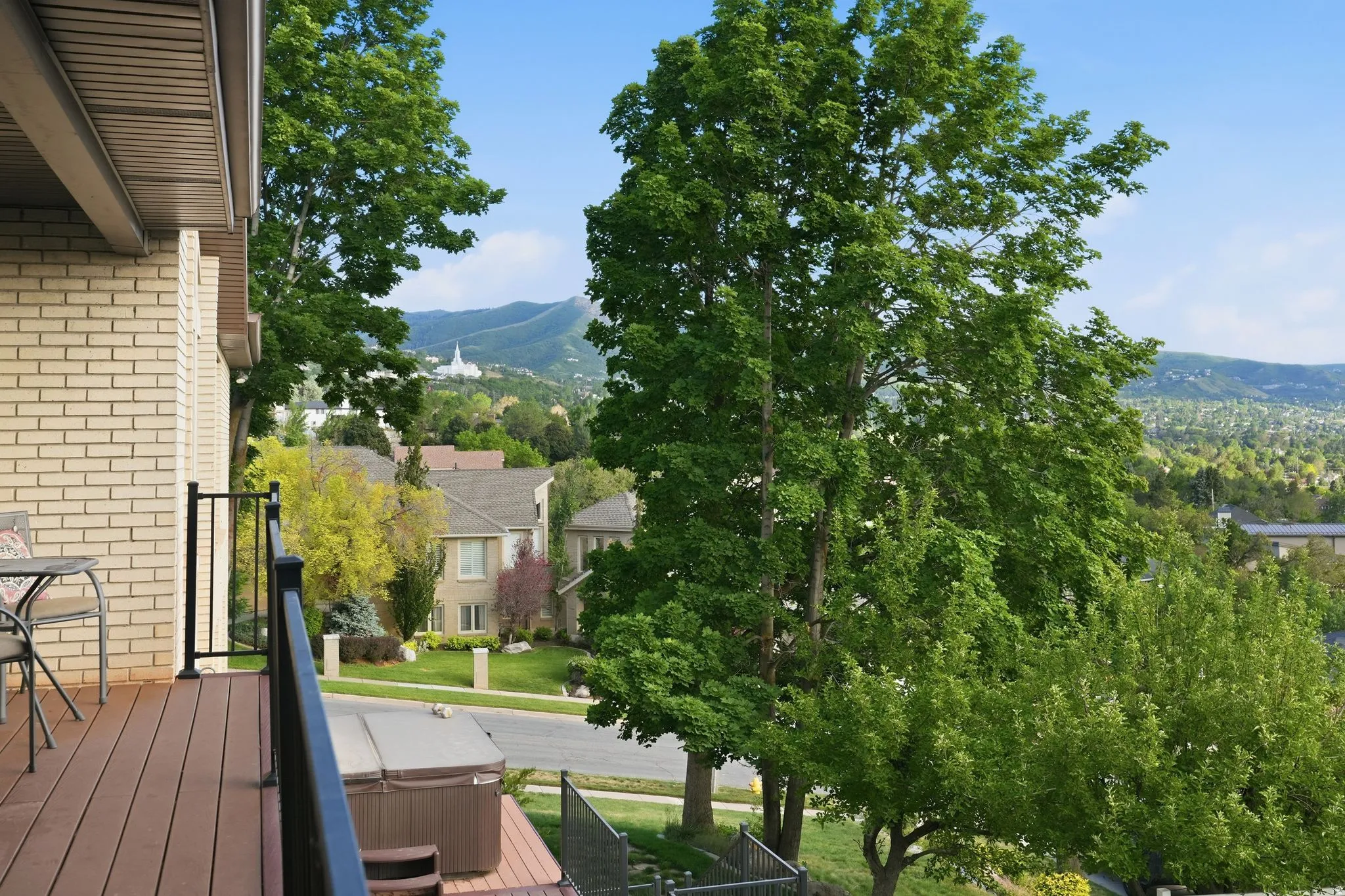 Expansive outdoor deck with composite decking and black metal railing