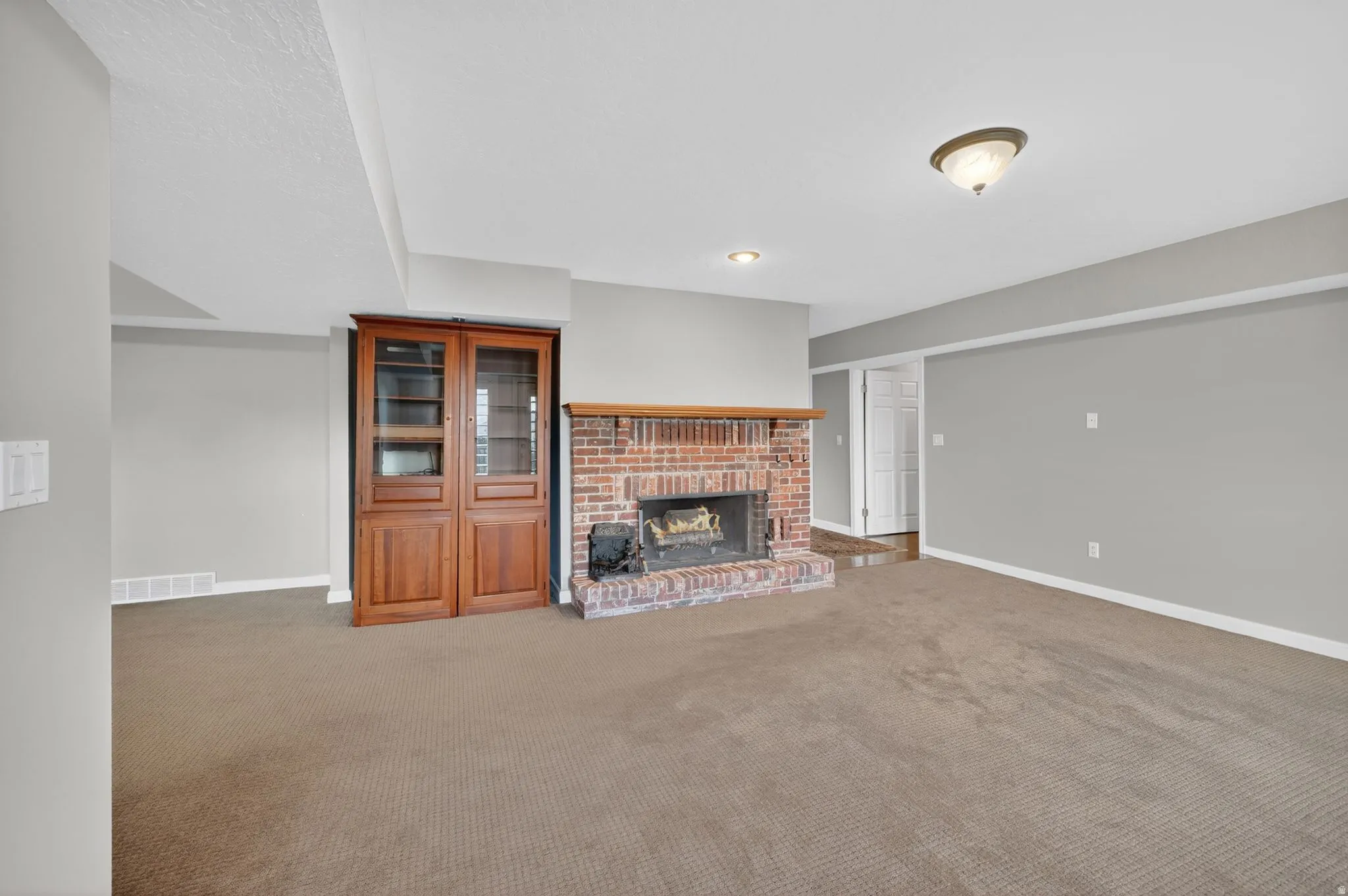 Brick fireplace with wood mantel