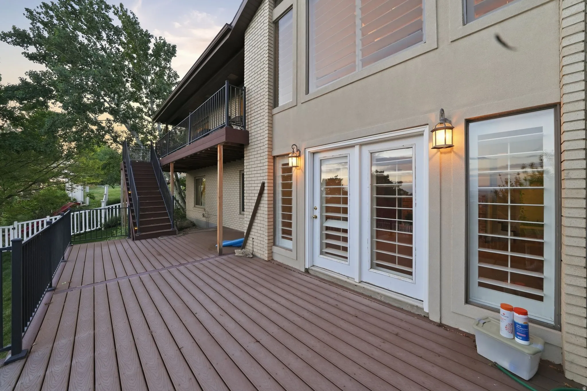 Spacious outdoor deck with composite decking and black metal railings