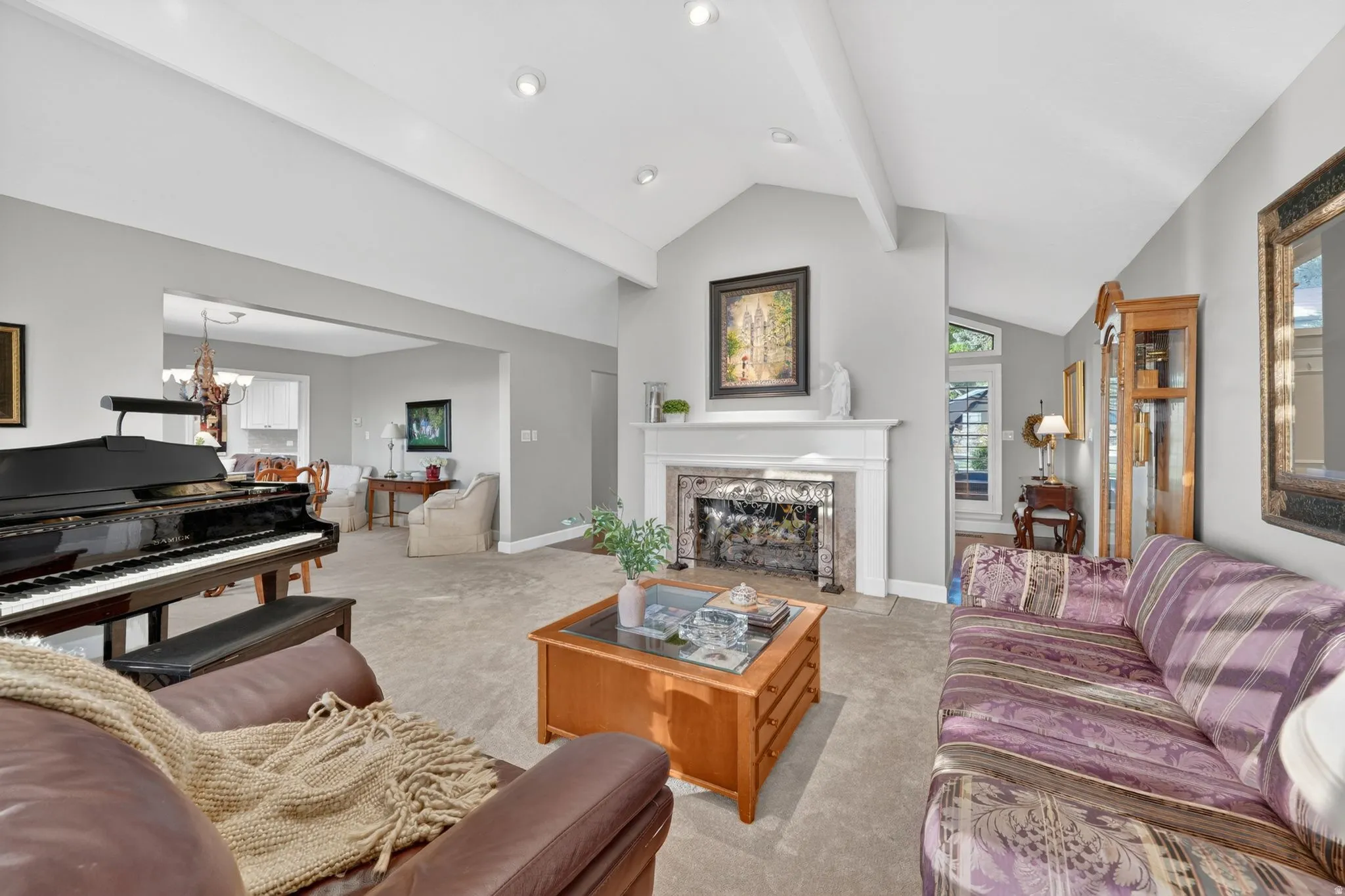 Living area featuring a vaulted ceiling with exposed beams, recessed lighting, and carpet flooring