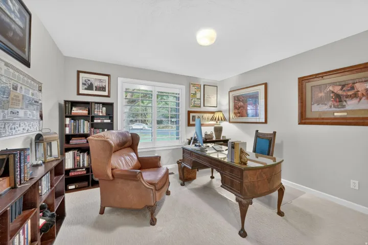 Bright interior space featuring light-toned carpeting and neutral wall colors