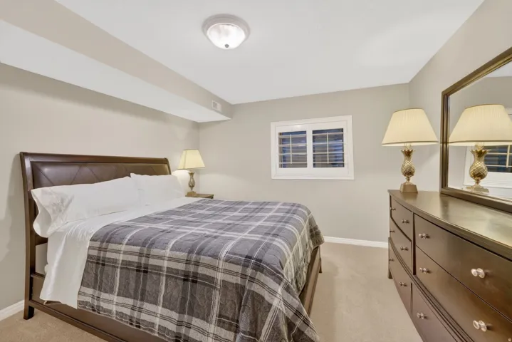 Carpeted room with neutral wall color and ceiling light fixture