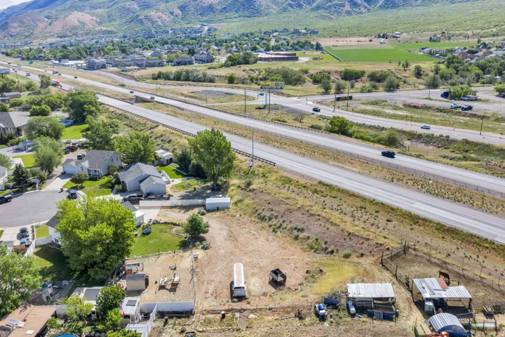Expansive land parcel featuring direct highway frontage and mountain backdrops