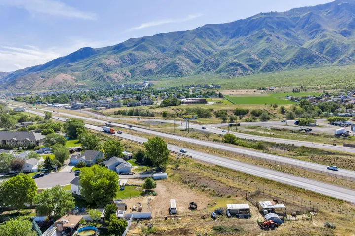 Expansive mountain scenery with a clear sky and multiple transportation routes