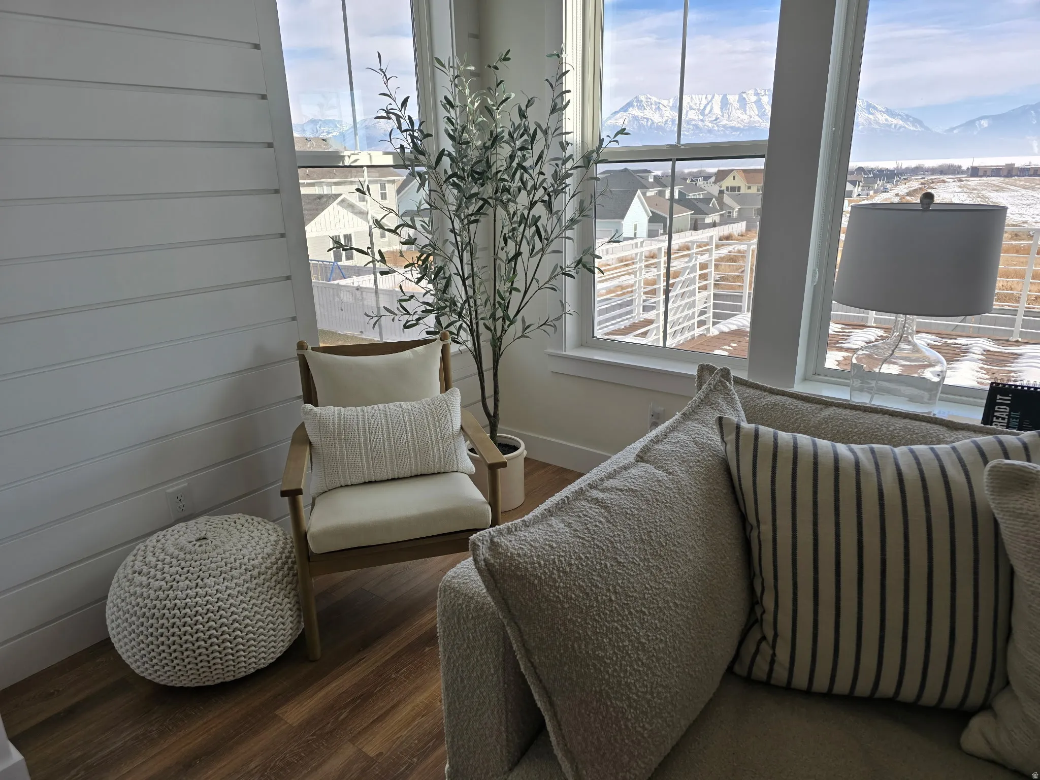 Interior space featuring floor-to-ceiling windows, wood-finish flooring, and shiplap wall paneling