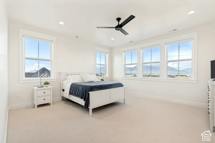The spacious primary bedroom offers a serene retreat, with breathtaking mountain views framed by every window