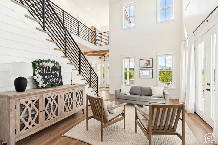 Soaring ceilings and abundant natural light make this spacious two-story living room warm, open, and ideal for gathering with family and friends.