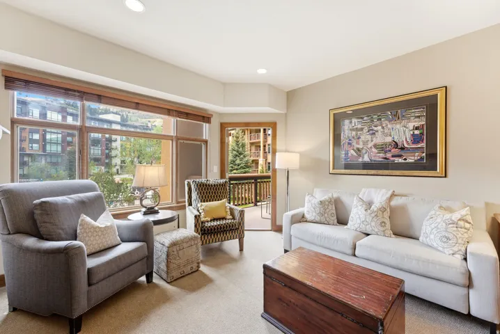 Living area featuring a wall of windows, recessed lighting, and access to an outdoor balcony