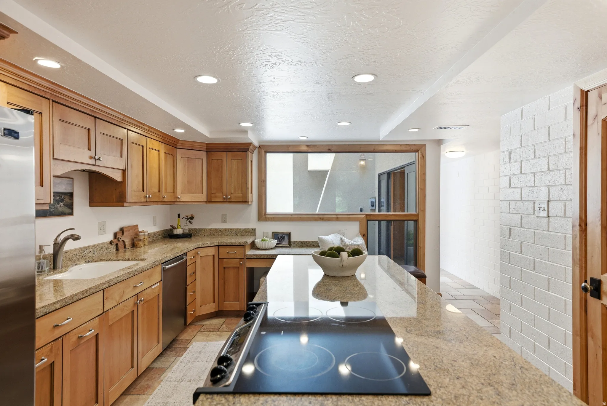 Kitchen featuring wood-finish cabinetry, granite countertops, and stainless steel appliances