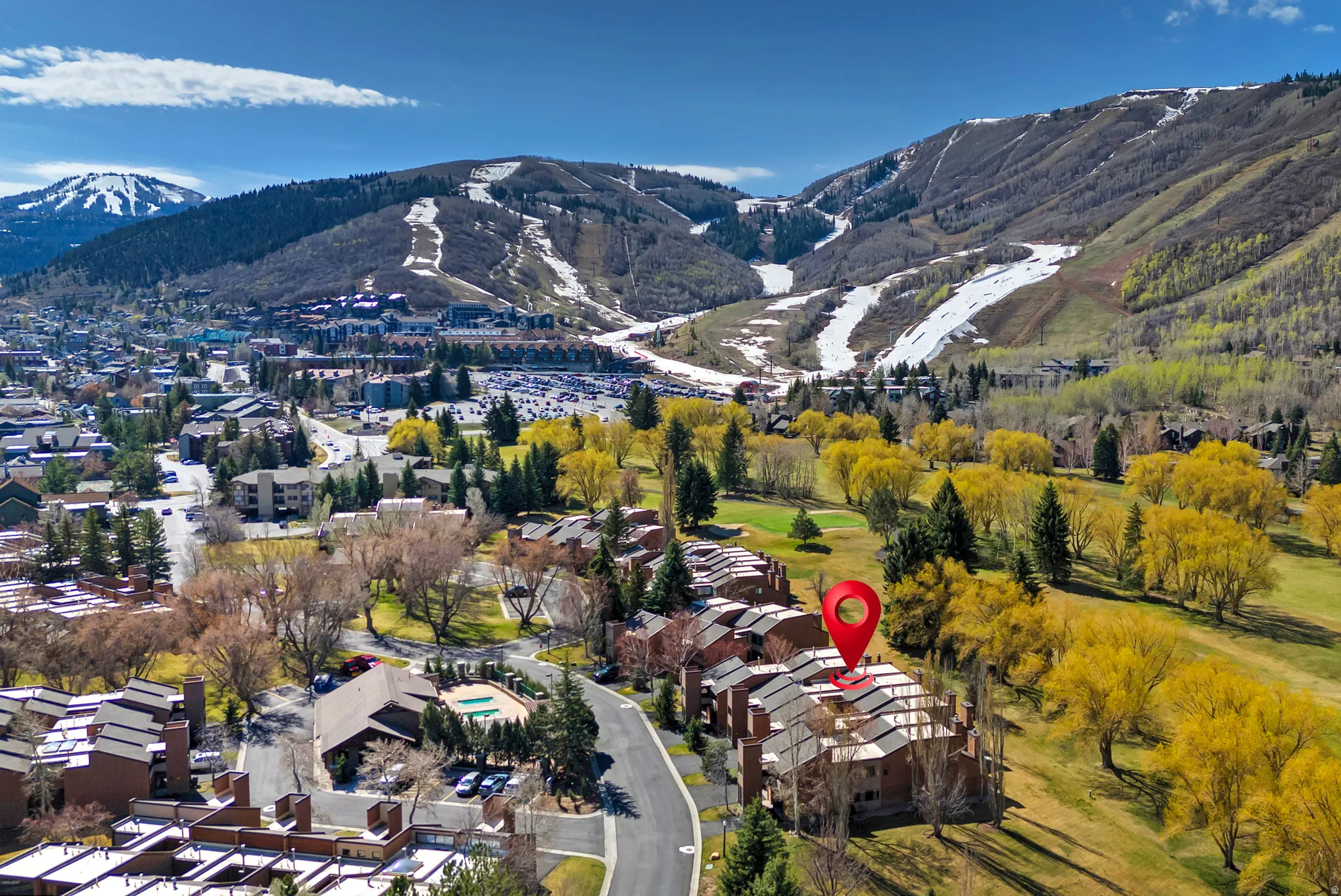 Aerial perspective showcasing a community of multi-story structures with pitched roofs