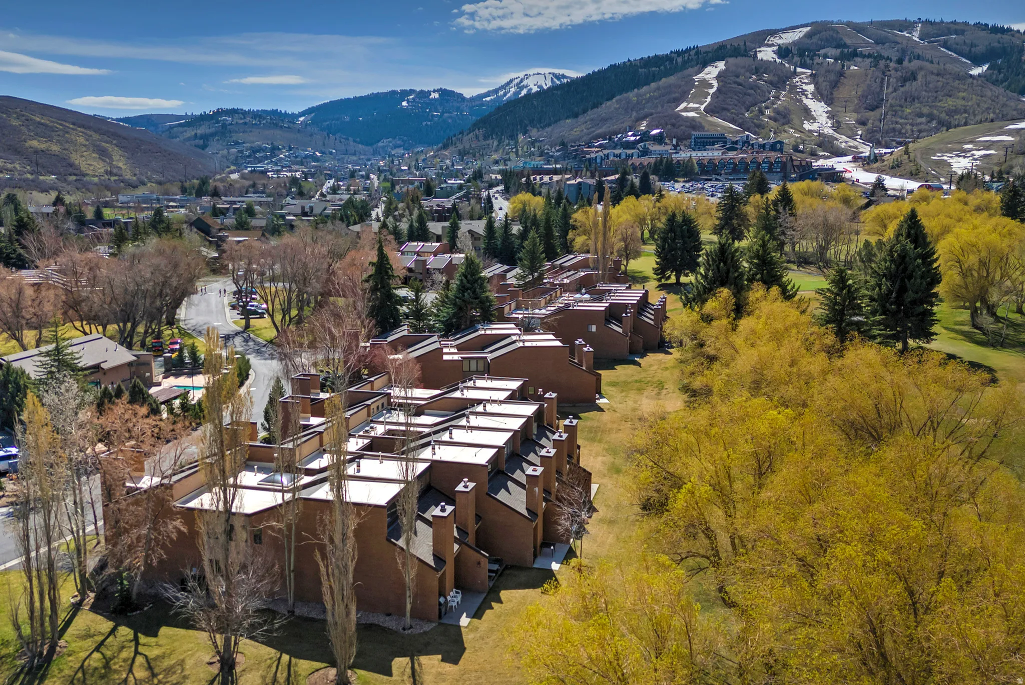 Multi-unit residential complex featuring brick exteriors, flat rooflines, and multiple chimneys