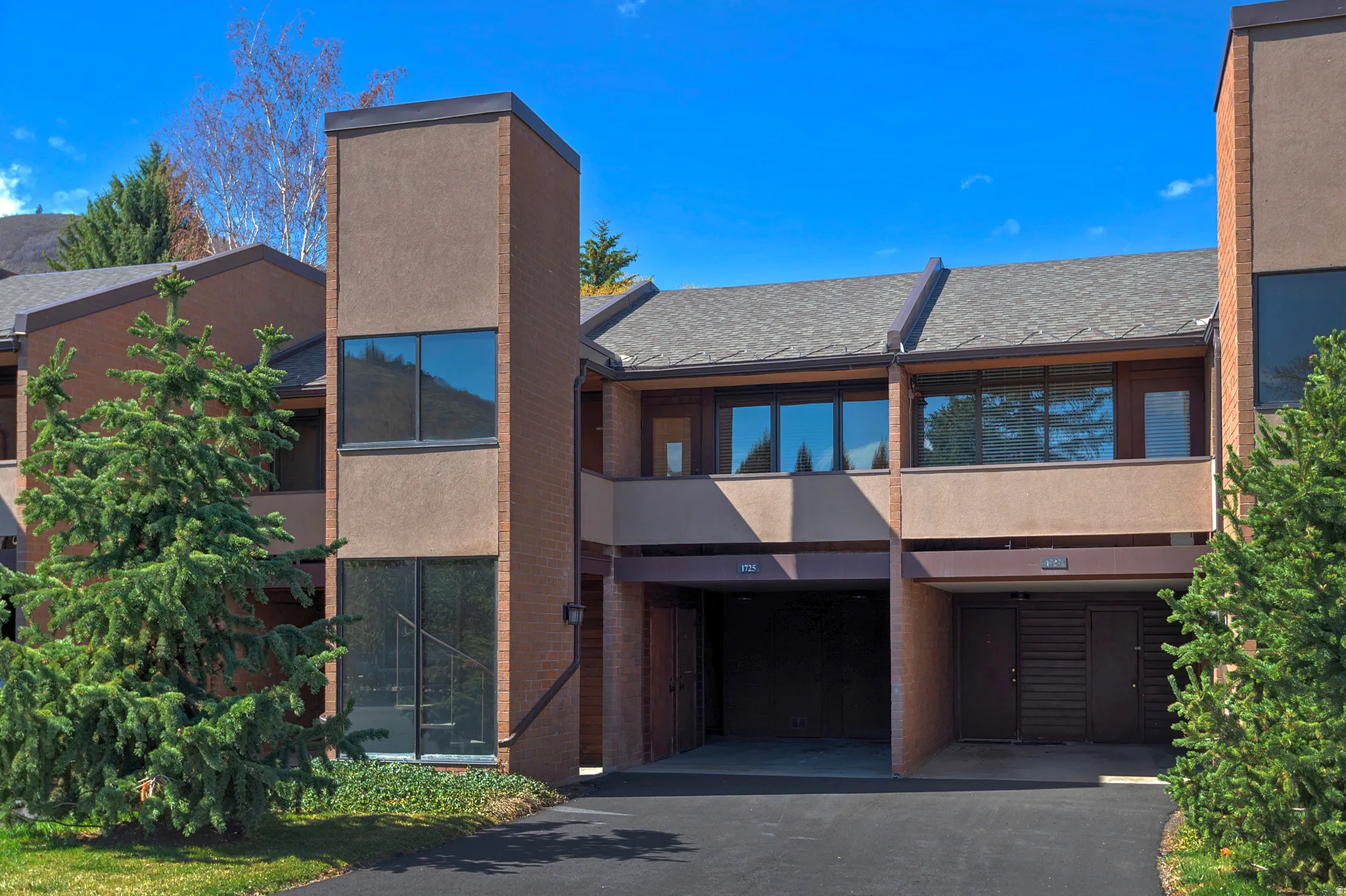 Multi-level facade featuring brick and stucco elements