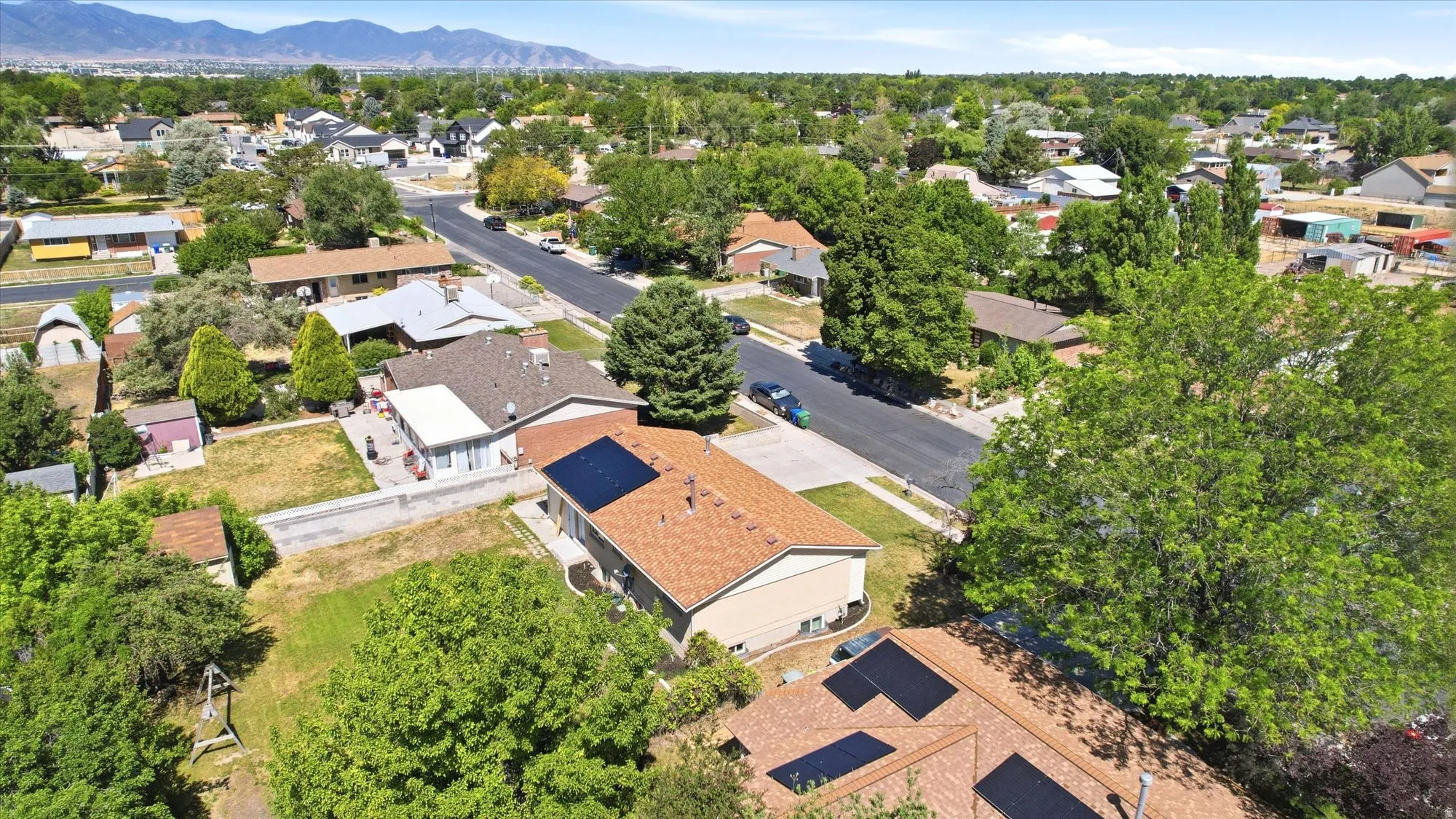 Aerial perspective of a neighborhood street with single-family residences