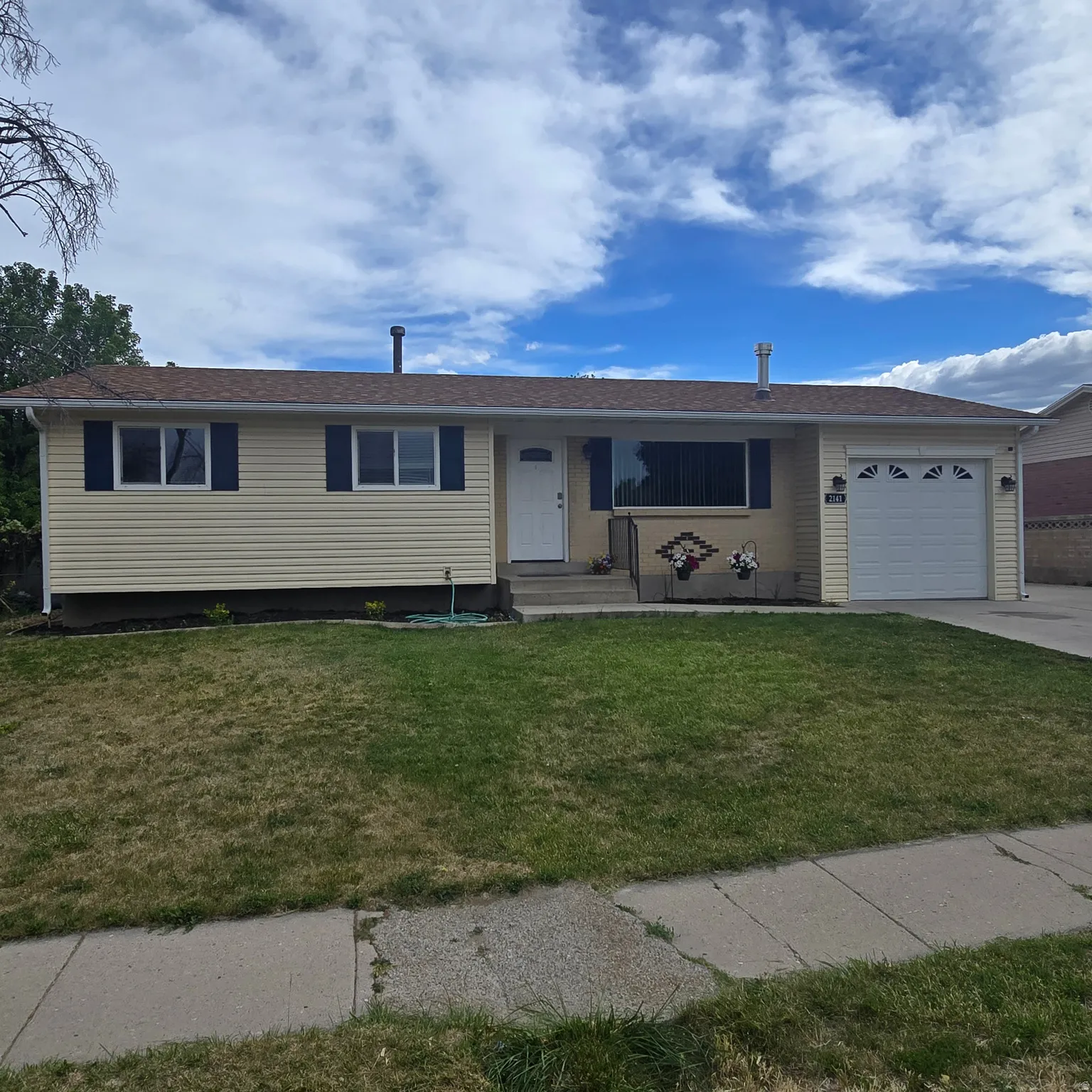 Extra deep 1 car garage with opener, RV Pad and large back yard with 2 storage sheds.