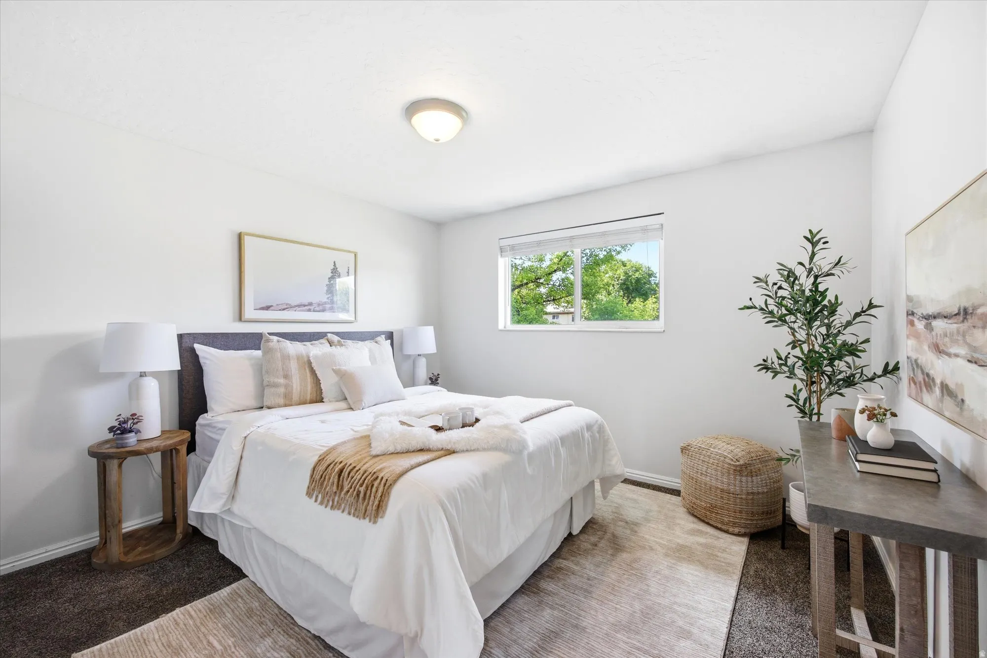 Bedroom featuring a single window with exterior greenery, neutral wall tones, and overhead flush mount lighting