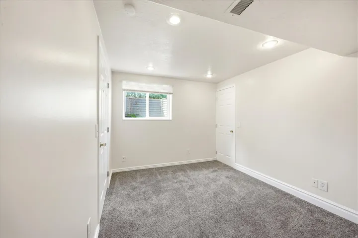 Den or office could be 5th bedroom featuring a window with horizontal blinds, recessed lighting, and gray carpet flooring. Just needs a door installed.