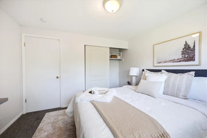Interior room featuring light-colored walls and dark carpet flooring