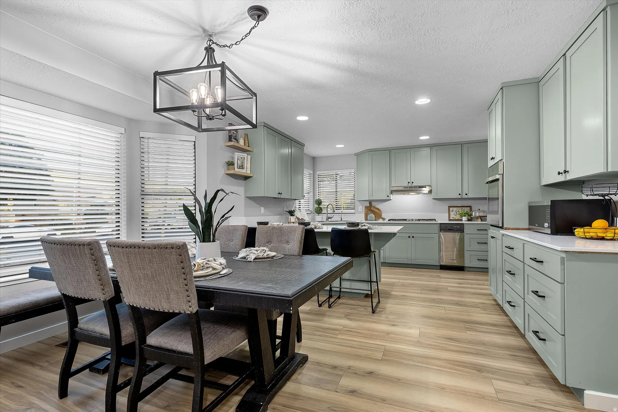 Open Kitchen & Dining Concept. Kitchen and dining area featuring light wood-finish flooring