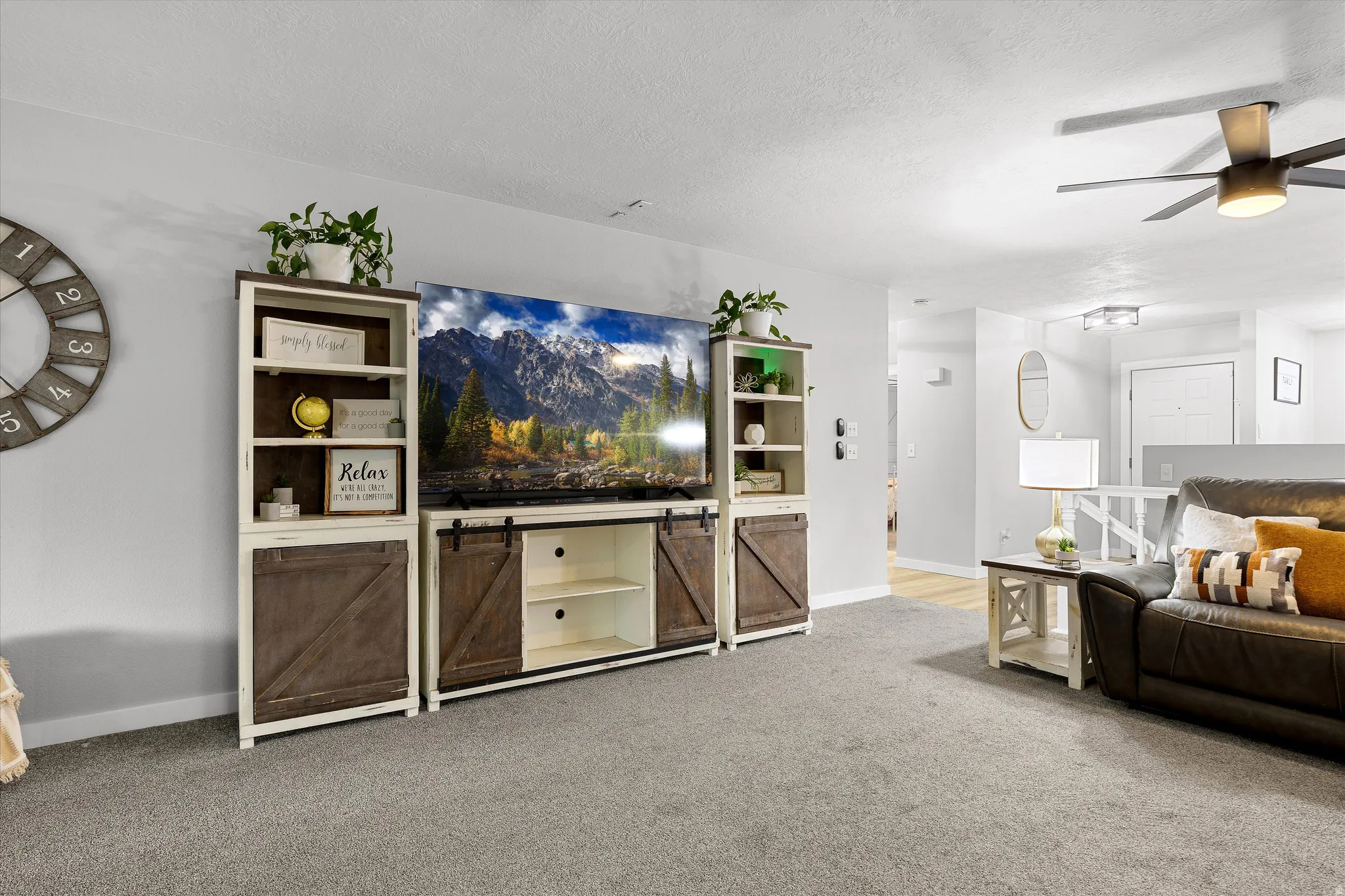 Main-Level Living Space. Spacious room featuring gray carpet flooring and white painted walls