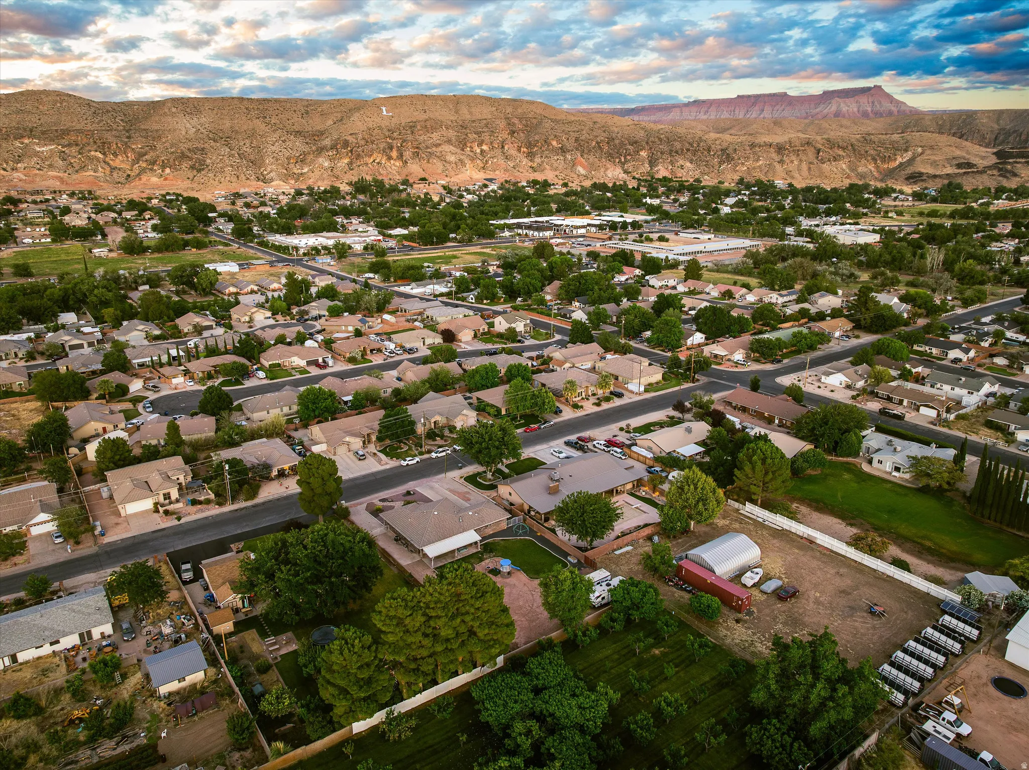 Aerial — Surrounding Area. Expansive aerial showcasing a residential neighborhood with varied single-story homes and mature tree landscaping