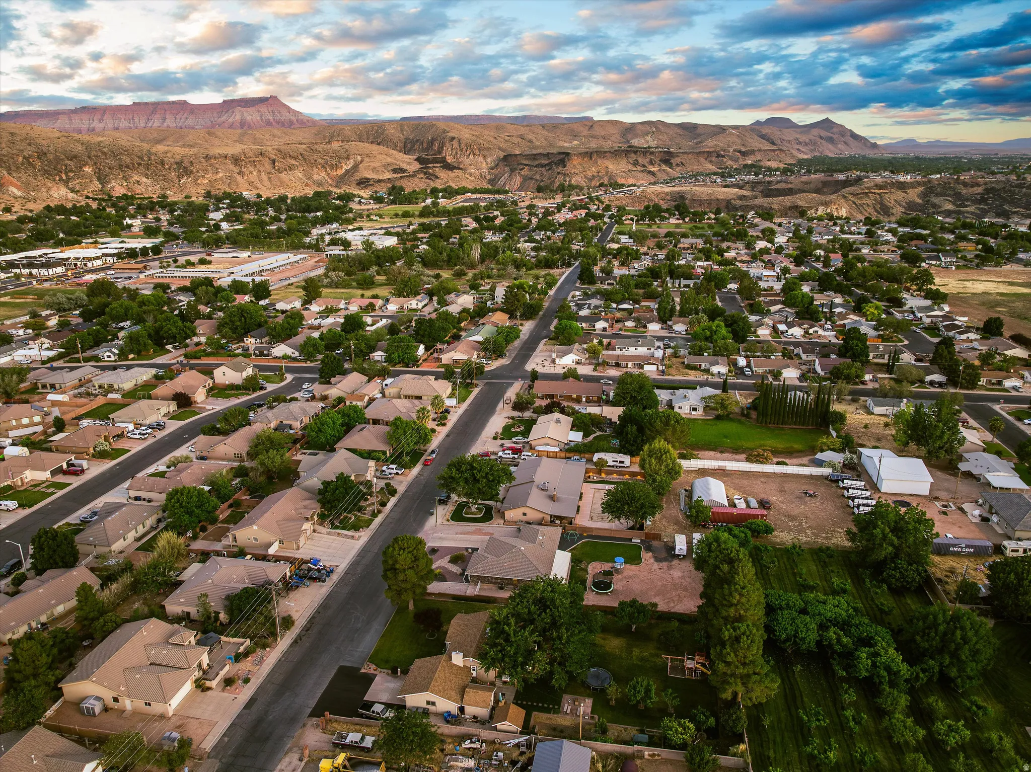 Aerial — La Verkin Neighborhood. Expansive aerial perspective showcasing a residential development with extensive tree coverage