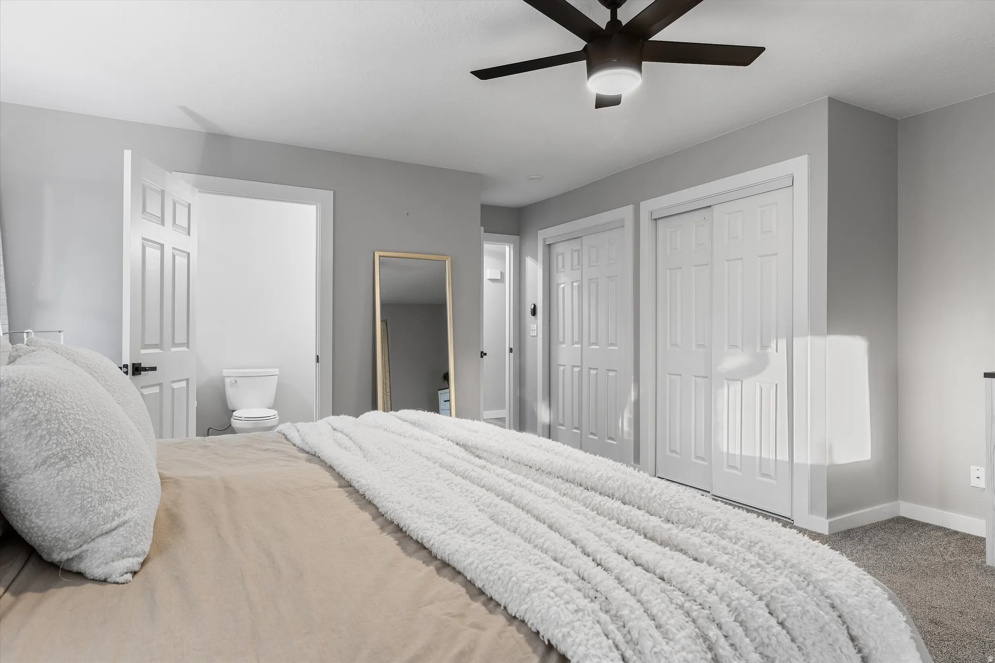 Primary Bedroom — Alternate View. Bedroom featuring light gray walls and plush carpet flooring