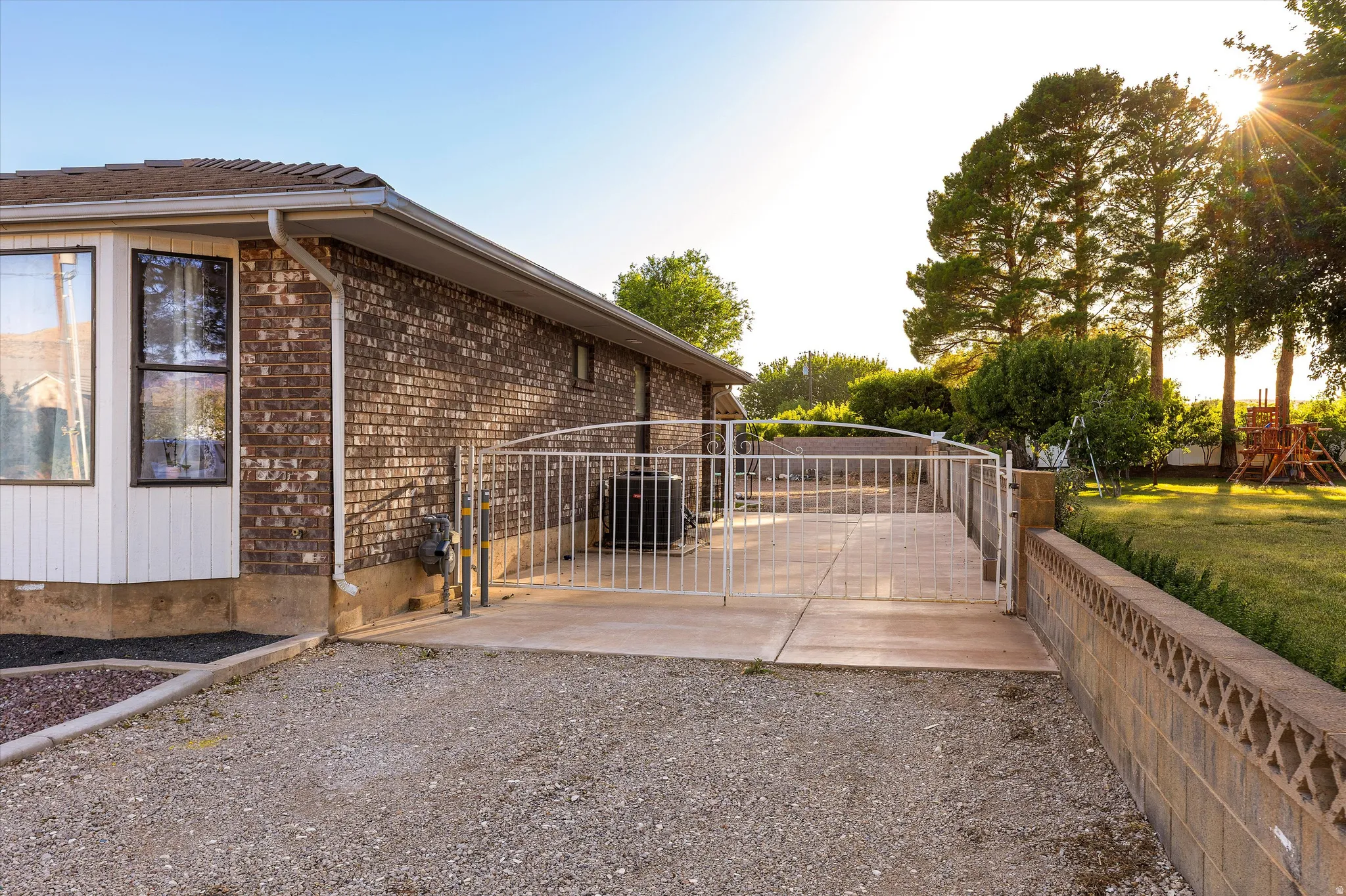 Fenced Side RV Parking. Brick exterior featuring a bay window with dark trim
