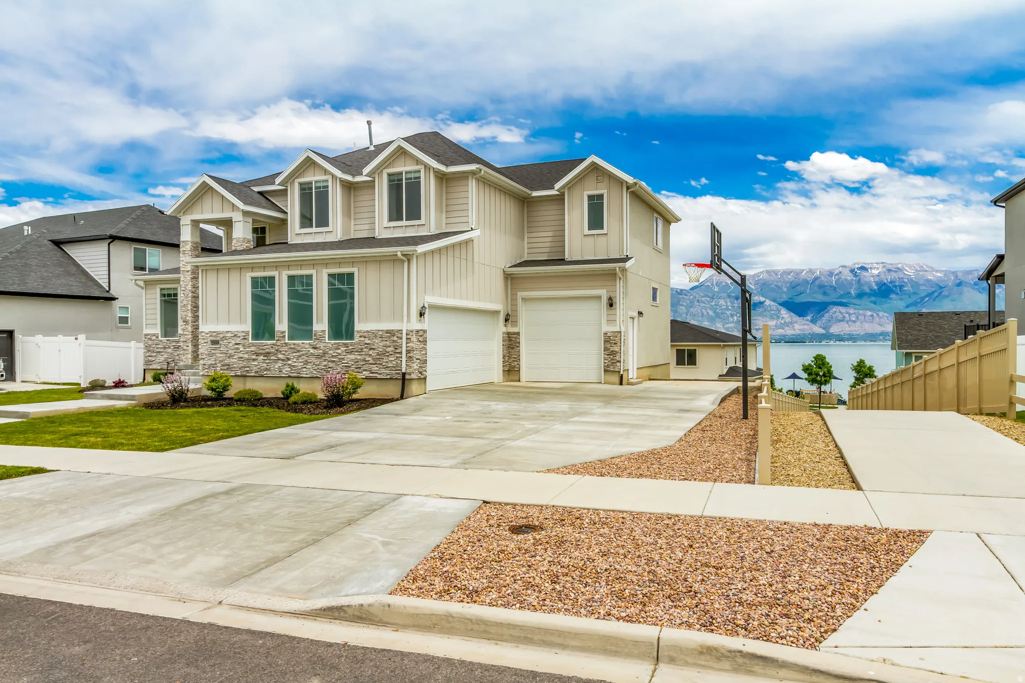 Home features a three-car garage and adjacent walkway to lake and park.