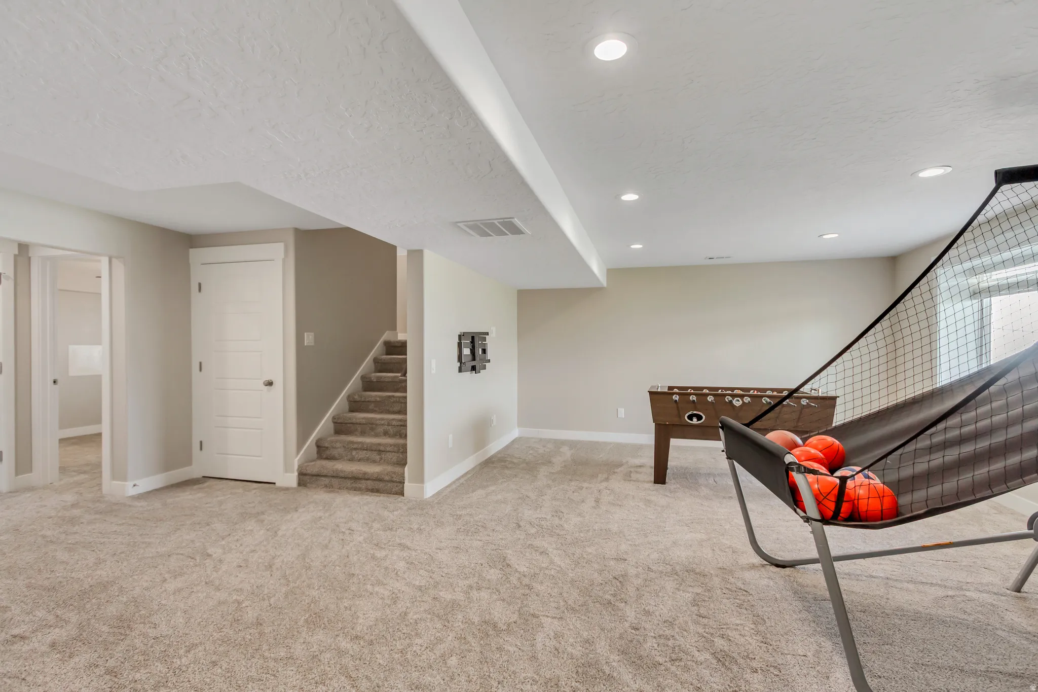 Lower level includes plush carpeting and recessed lighting.