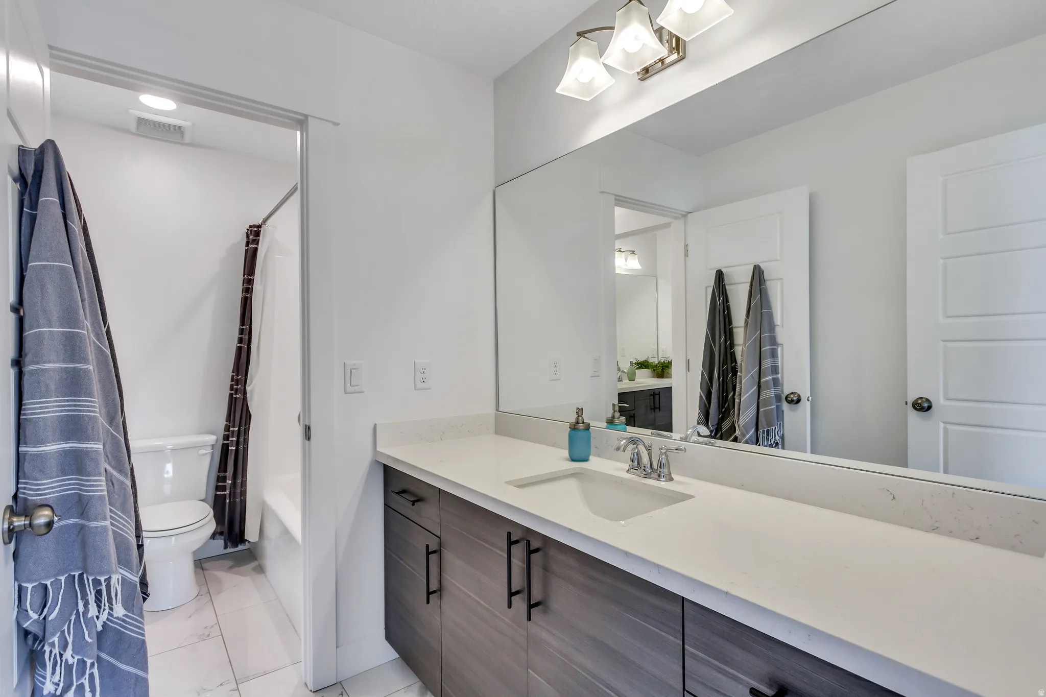 Second vanity area in second bathroom leads to fourth bedroom upstairs.