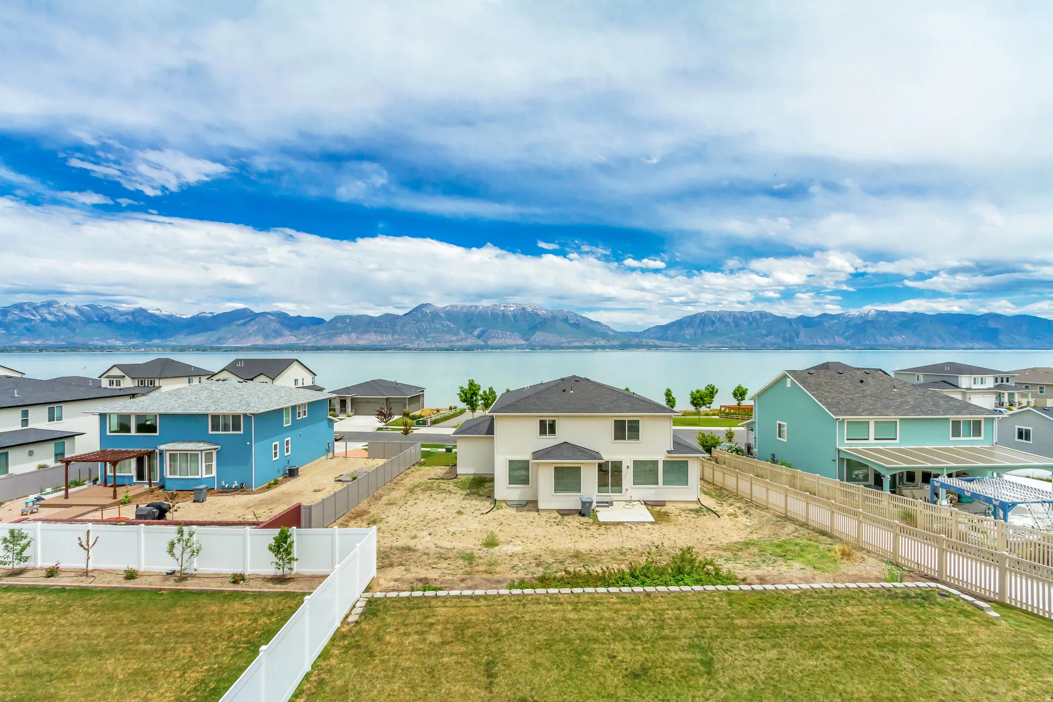 View from primary bedroom. Home features waterfront proximity and mountain backdrop.