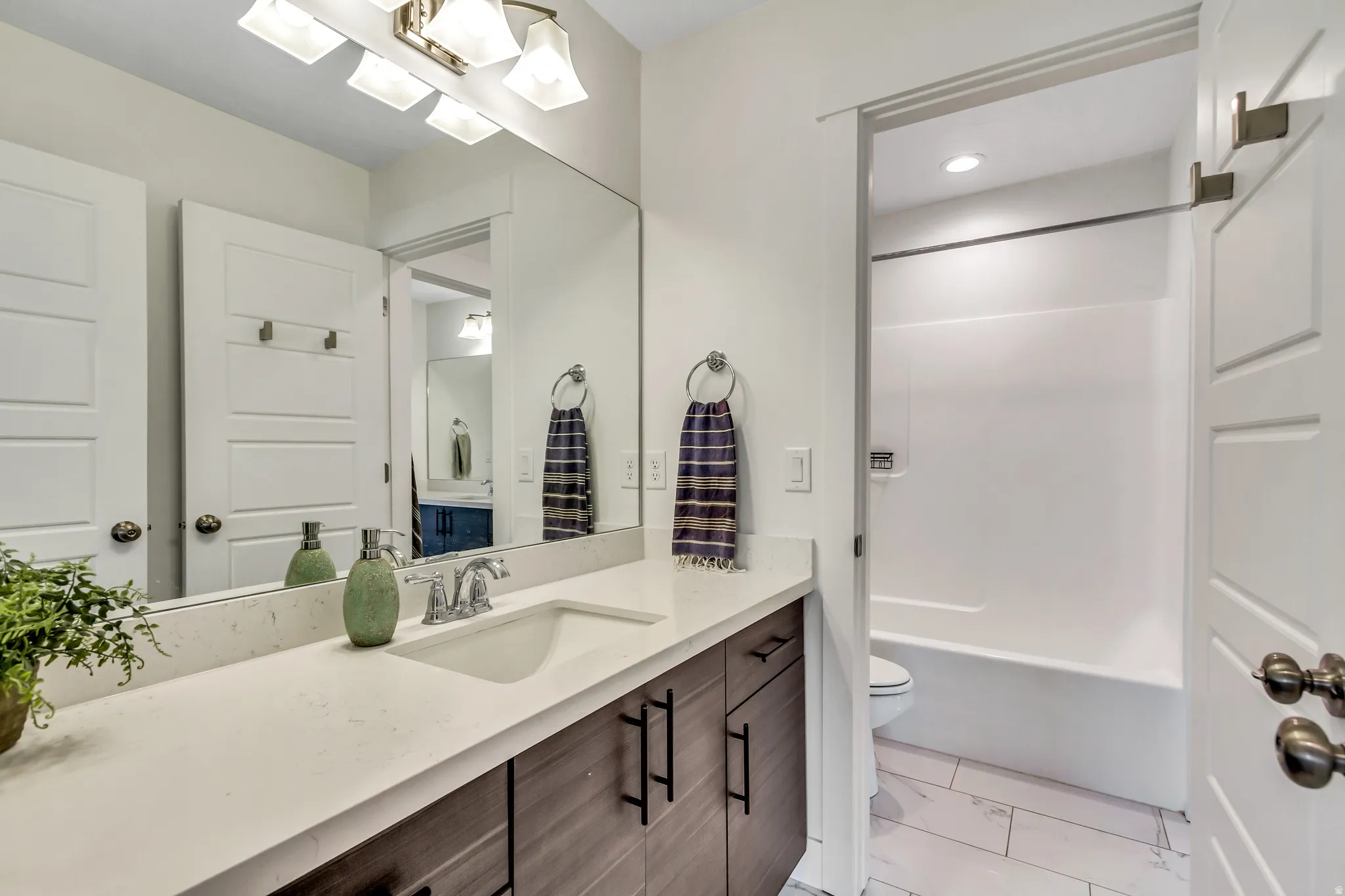 Second bathroom upstairs has 2 vanity areas with a private tub/shower/toilet area in between.