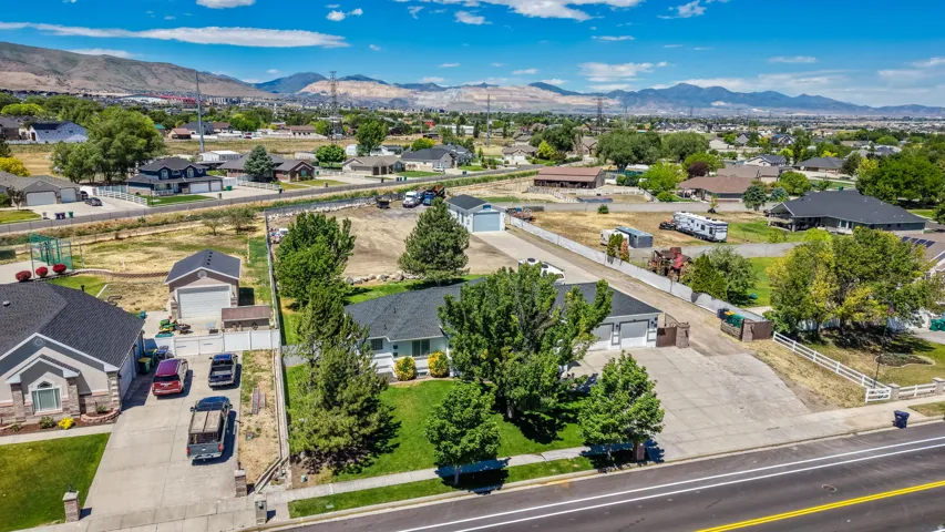 Expansive property featuring a single-story residence, detached garage, and a large open yard space