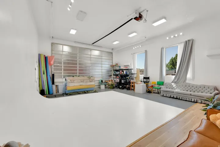 Photo Studio Spacious interior featuring a wide coved wall, large rectangular windows, and overhead track lighting