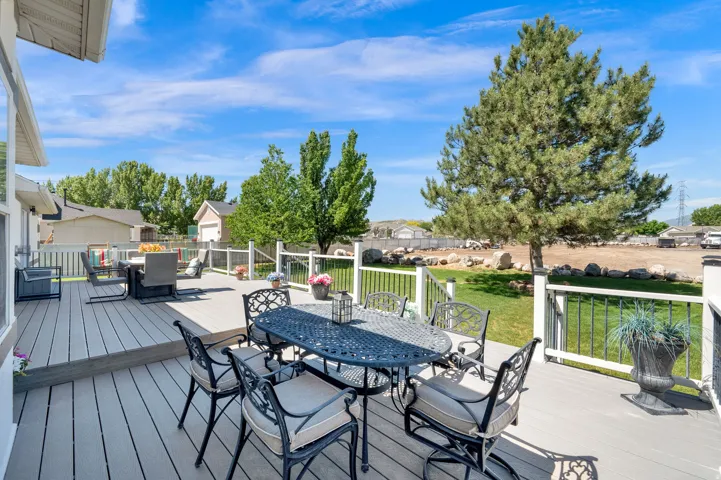 Expansive composite deck featuring white railings and black balusters