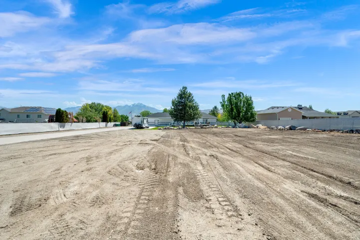 Cleared lot featuring a level building pad and mountain backdrop