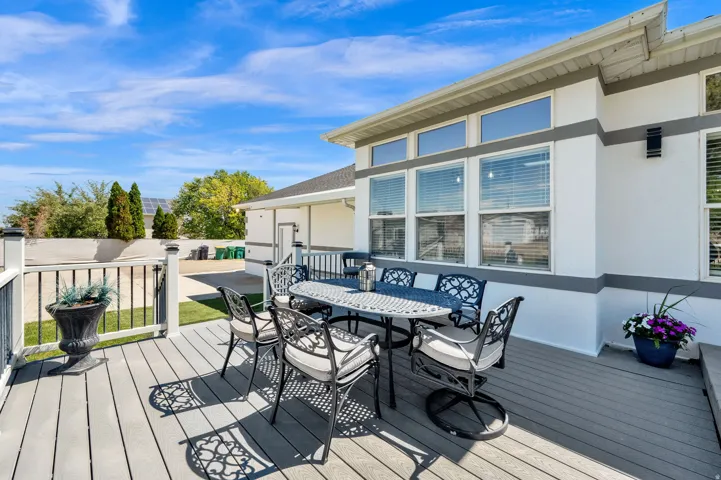 Spacious composite deck with white railings and black balusters