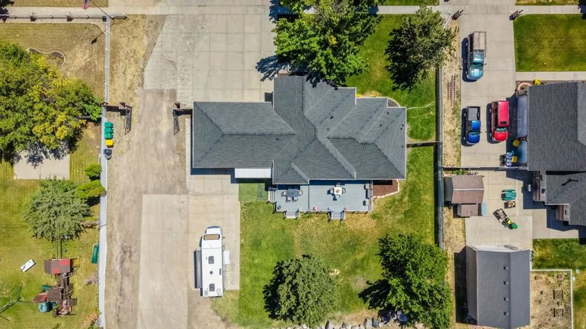 Single-story residence with a multi-gabled roofline and an expansive concrete driveway