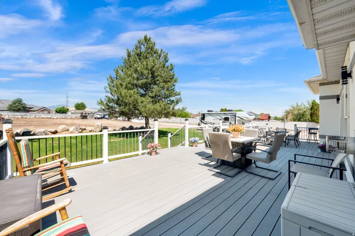 Spacious composite deck with white railings and black balusters