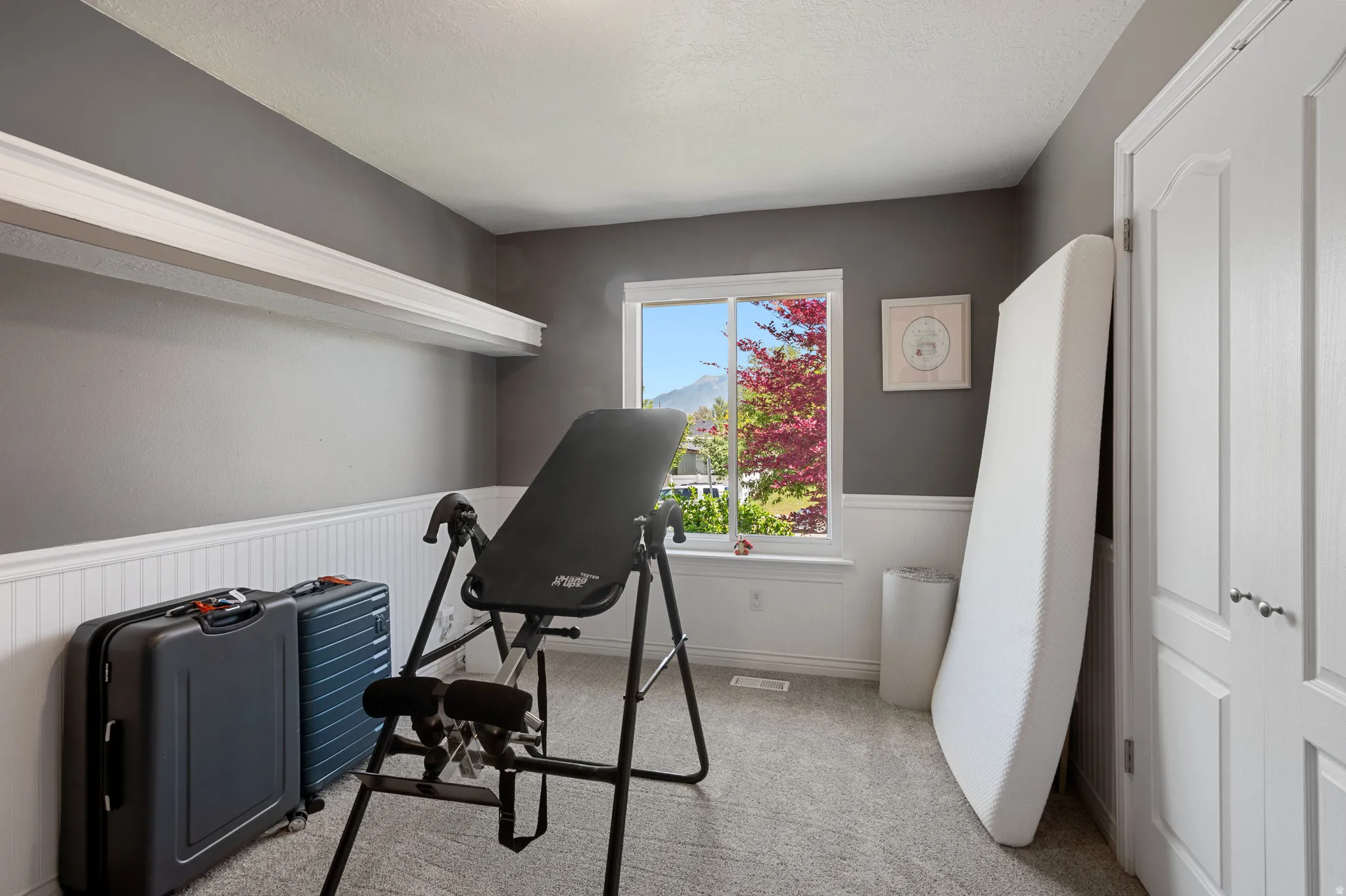 Room with gray painted walls and white beadboard paneling