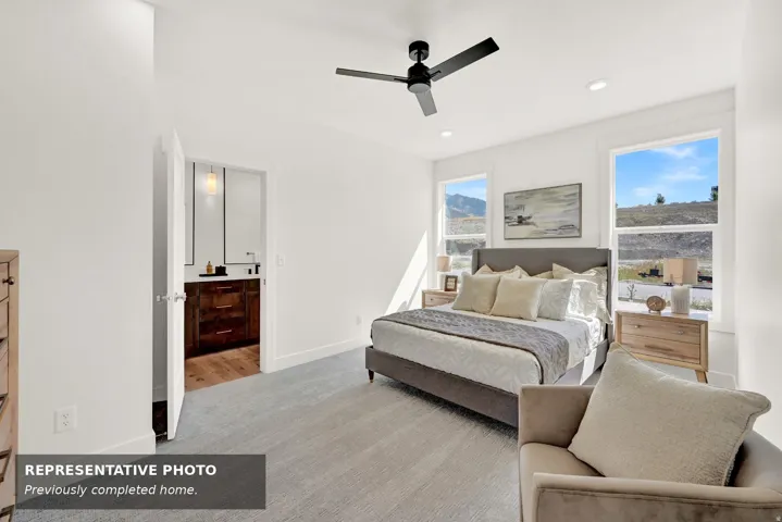 Spacious room featuring multiple windows, a ceiling fan, recessed lighting, and soft grey carpeting
