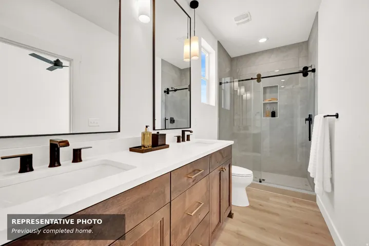 Dual sink vanity with quartz countertop and wood-finish cabinetry