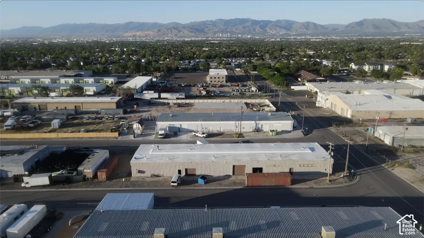 Industrial property featuring multiple buildings with flat roofs and a large paved area