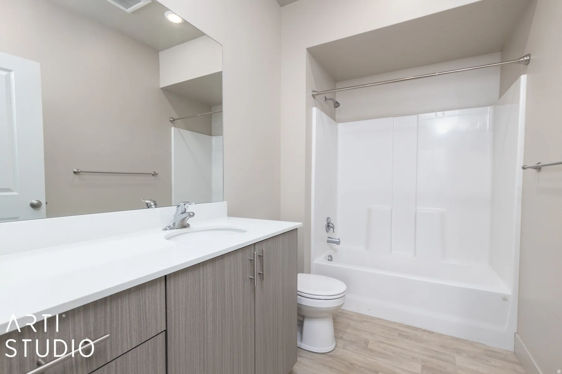 Bathroom featuring a vanity with light wood-finish cabinetry, a white countertop, and an integrated sink